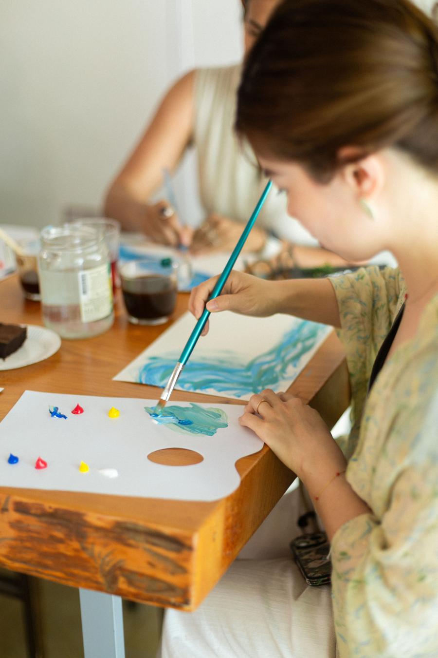 A hand painting with a brush
