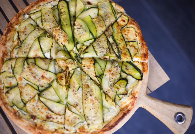 A courgette tart on a wooden board