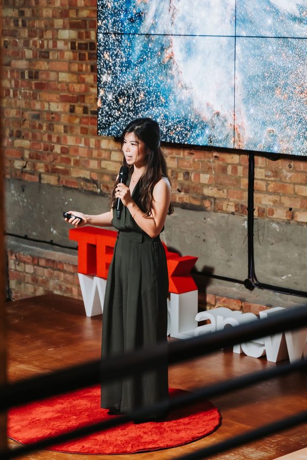 Joei Chan speaking on the TEDx stage